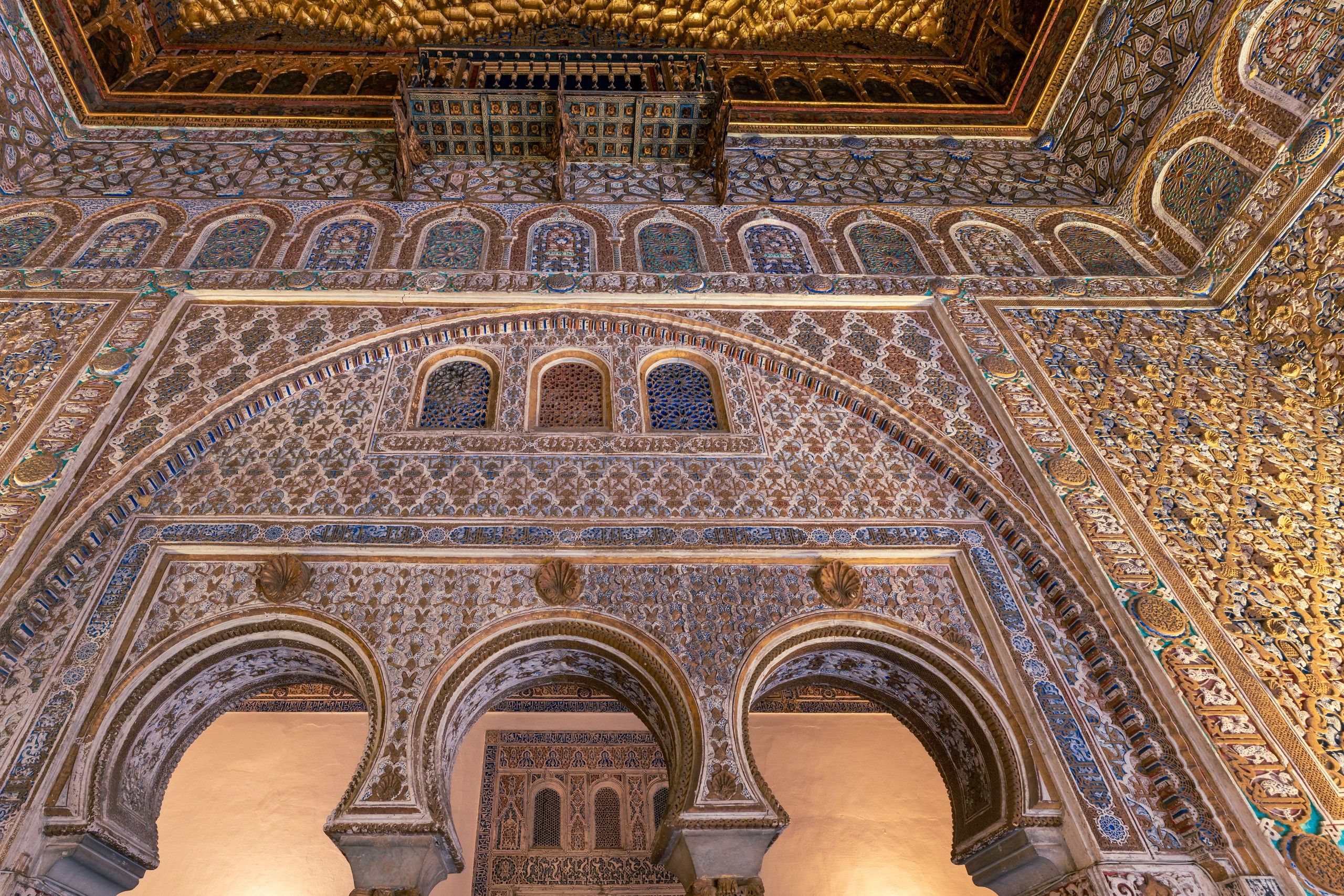 Intricate Moorish architectural interior with arches and detailed tile patterns.