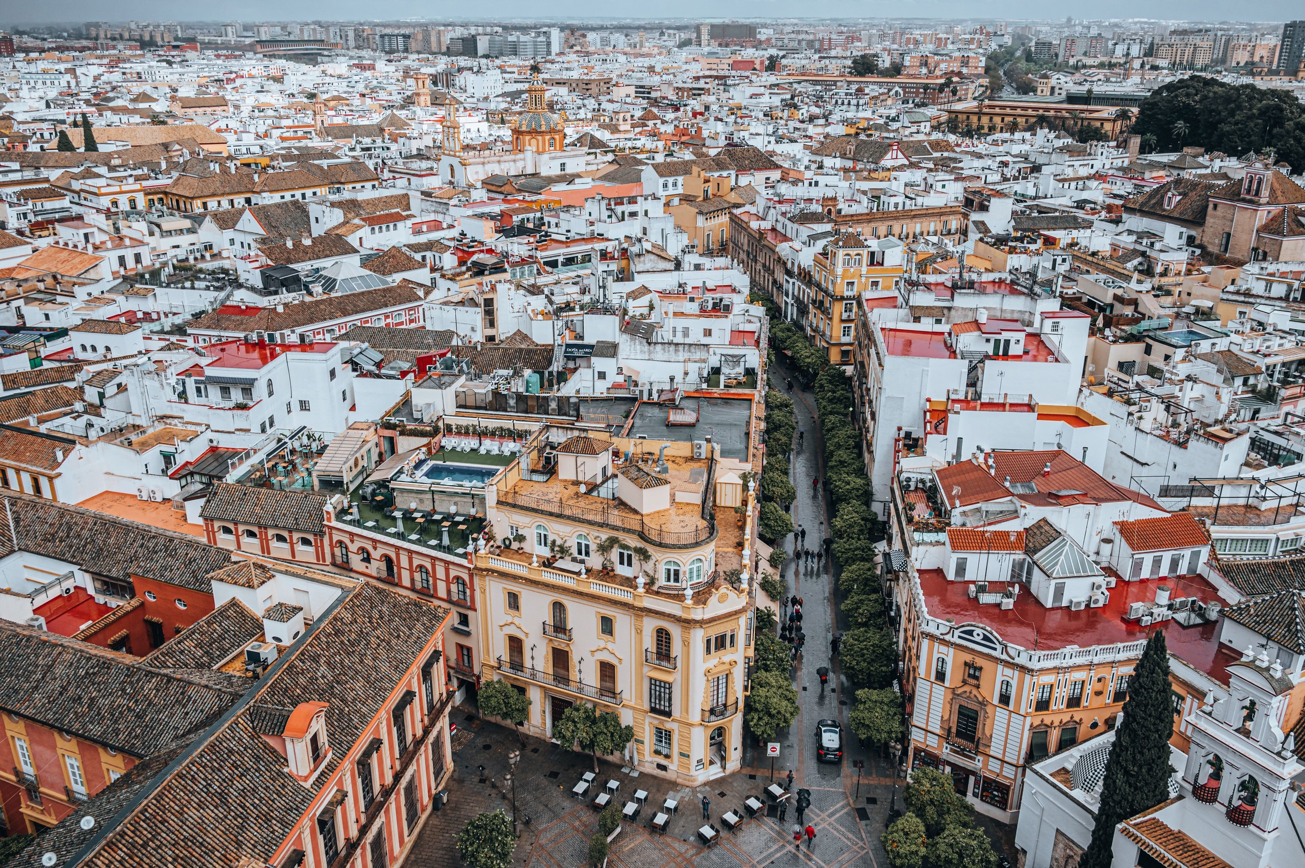 Aerial view of a cityscape with densely packed buildings and narrow streets.