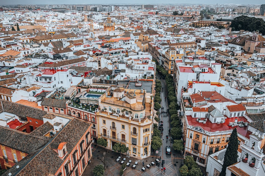 Aerial view of a cityscape with densely packed buildings and narrow streets.